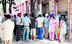 People queue up for the birth and death certificates at the municipal corporation office in Amritsar