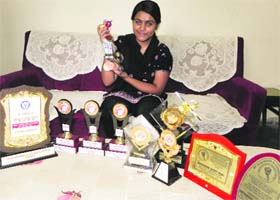 Sandeep Kaur showing the medals and trophies she won in national and state-level games