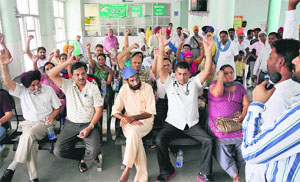 Members of the PCMS Association raising slogans against the state government at the OPD in the Civil Hospital on Monday