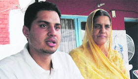 Inspector Sucha Singhs son Parminder and his mother at their residence on Monday.