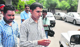 Victim Pawan Kumar outside the Reliance Fresh store in Phase V, Mohali, on Monday.