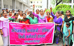 Anganwari workers stage a demonstration in support of their demands in Dehradun on Monday.