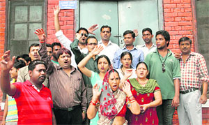 Members of the Bharatiya Janata Yuva Morcha hold a protest against the tardy public distribution system in Dehradun on Monday. 