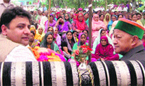 Chief Minister Virbhadra Singh with minister Sudhir Sharma during an election rally at Jogindernagar in Mandi on Monday.