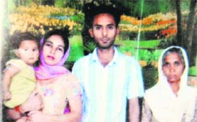 A file photo of Bhupinder Singh, who commited suicide, with his family