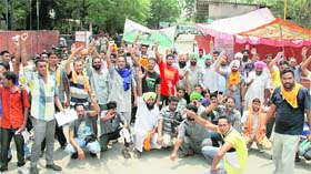 Contractual employees of the Punjab Roadways stage a protest outside the depot for the 47th day in Jalandhar on Monday