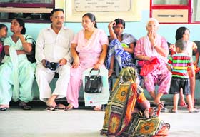 Patients wait for their turn in front of the OPD at the Civil Hospital in Jalandhar on Monday