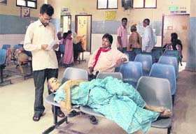 Patients wait for their turn in front of the OPD at the Civil Hospital in Jalandhar on Monday