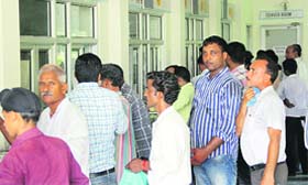 Some of them queue up at counters at the Suwidha Centre in Jalandhar on Monday