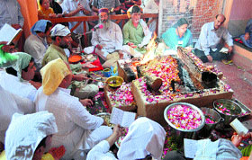 Kashmiri pandits perform prayers at a mahayajna at Bhagwan Gopinathji Ashram in Srinagar on Monday.