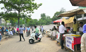 IIlegal shops set up on the footpath outside the Deputy Commissioners office in Ludhiana on Monday.