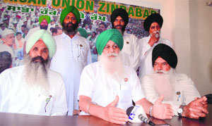 Ajmer Singh Lakhowal (centre), president, BKU, addresses a press conference in Ludhiana on Monday. 
