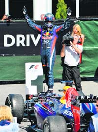Sebastian Vettel atop his car after winning the Canadian GP on Sunday