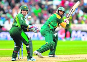 Hashim Amla plays one behind the wicket as Pakistan wicketkeeper Kamran Akmal looks on during the Champions Trophy match on Monday