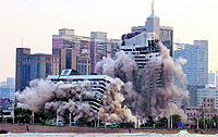  27-year-old hotel building is demolished using explosives to make way for re-development on the water front in Qingdao in eastern Chinas Shandong province on Monday. It was one of the oldest five-star hotels in the province