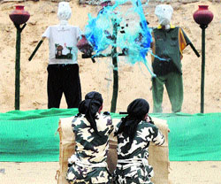 CRPF woman commandos who have undergone a training course at the Jodhpur Police Academy demonstrate their skills at the CRPF Academy at Kadarpur in Gurgaon on Tuesday.