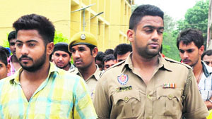 Policemen rescue Amarpreet Singh, a student of Mehr Chand Polytechnic, who was attacked by some youths on the campus, in Jalandhar on Tuesday.