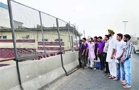 Members of the Action Against Corruption, an NGO, get safety grills installed on an elevated road in Ludhiana on Tuesday