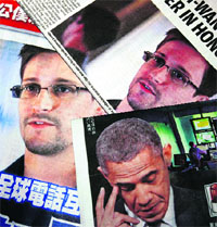 Photos of Edward Snowden and US President Barack Obama are printed on the front pages of local newspapers in Hong Kong on Tuesday. 