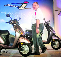 Honda Motorcycles and Scooters India president and CEO Muramatsu poses with Honda Activa-i during its launch in New Delhi on Wednesday. Activa-i, priced at Rs 44,200 (ex-showroom Delhi)