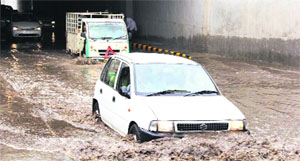 Commuters faced trouble as water accumulated under the newly constructed railway under bridge on Mansa road