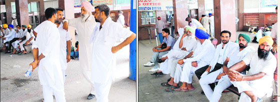 Farmers from the Malwa region wait for labourers to arrive at the Bathinda railway station on Wednesday. With the beginning of the paddy transplantation season, the labourers, especially those from states like Bihar and Uttar Pradesh, are much in demand and the farmers negotiate with them, even putting up signboards announcing various offers to woo them, at the city railway station. 