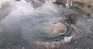 a overflowing manhole after the showers on Tuesday in Bathinda.