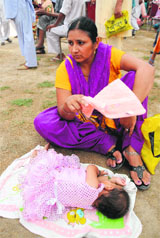 A woman complainant from Ferozepur was seen fanning her sleeping child as she awaited her turn at the domestic disputes redressal darbar held by the police in Bathinda on Tuesday.