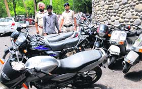 The accused along with the stolen two-wheelers in police custody at Sector 17, Chandigarh, on Wednesday