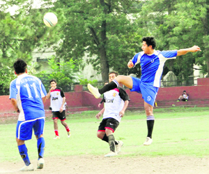 Players in action during a match in the BS Negi Memorial Football Tournament played at Ambedkar Stadium in Dehradun on Wednesday.