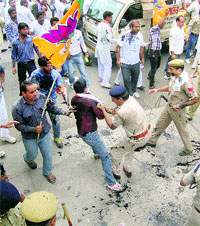 Policemen cane-charge HJC and BJP workers outside Naveen Jindals house in Hisar on Wednesday. 