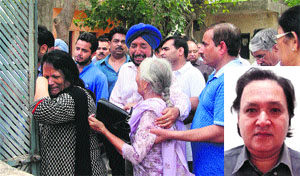 Wailing relatives of Haryana Additional Chief Secretary Dr Harbaksh Singh (inset) in Gurgaon on Wednesday.