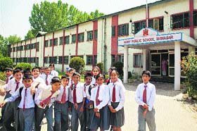 Students pose for a photograph in front of the school