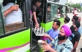 Devotees offer sweet water to bus passengers on the occasion of the 408th Martyrdom Day of Guru Arjan Dev in Jammu on Wednesday.