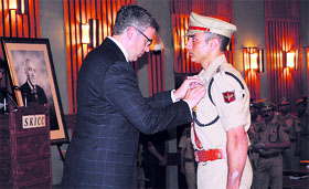 Chief Minister Omar Abdullah honours a police official at the award ceremony of Sher-i-Kashmir Police Medals at the Sher-i-Kashmir International Conference Centre in Srinagar on Wednesday.