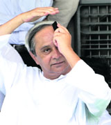 Odisha CM Naveen Patnaik adjusts his hair at a rally in New Delhi on Wednesday.