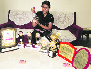 Sandeep Kaur with medals and trophies she won in national and state-level games.
