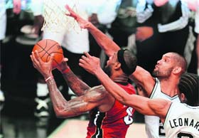 Tim Duncan (right) plays tough defense against Lebron James during game 3 of the NBA finals on Tuesday