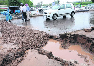 A damaged road being repaired in Chandigarh. 