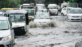 Following a heavy spell of pre-monsoon showers, motorists face a tough time crossing the inundated road at Kapurthala Chowk.