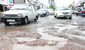 A badly potholed road in Jalandhar on Thursday.