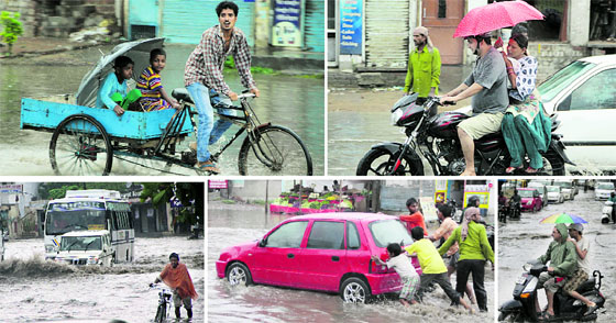 (Clockwise from top) Children enjoy a cart ride under an umbrella; a couple takes shelter from rain under an umbrella as they make their way through an inundated road; a scooterist looks as vehicles move in a bumper-to-bumper traffic; labourers push a car after it got stuck; and a cyclist moves after rain in Jalandhar on Thursday.