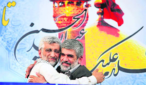 A supporter hugs Iranian presidential candidate Saeed Jalili (L) during a rally in Tehran on Wednesday. 