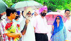 Tourism Minister Sarwan Singh Phillaur (second from left) waits for Sukhbir Singh Badal at the venue of the inauguration of new MC building at Ranjit Avenue in Amritsar on Friday