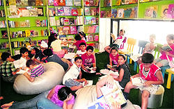 Children read books at a book store in Amritsar on Friday