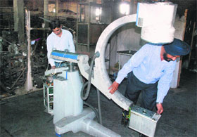 Workers check a machine after a fire broke out in Recorders and Medicare Unit Systems in Industrial Area, Phase I, Panchkula.