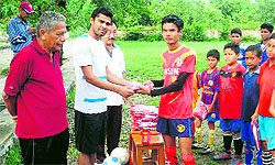 Mohun Bagan midfielder Manish Maithani distributes uniforms among young footballers at Gorkha Military Inter-College in Dehradun on Friday