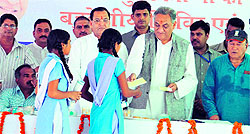 Bahuguna distributes FDs to girl students at a function