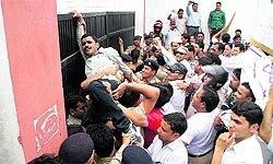 BTC teachers protest at the office of Director, Education, in support of their demands in Dehradun on Friday