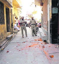 Policemen inspect the site where the clash took place in Lambi Mohalla